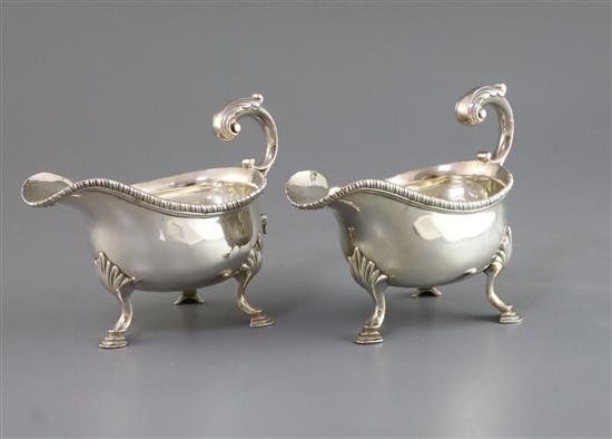 A pair of early George III silver sauceboats with flying scroll handles, maker, F.M, (unidentified Grimwades), London, 1766, 20 oz.